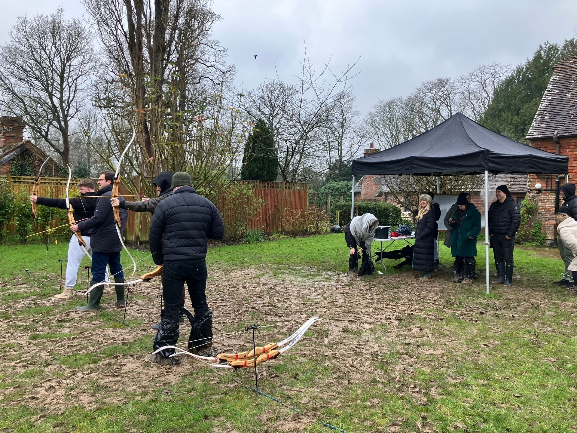 Archery hire in Hampshire, people holding bows and others watching