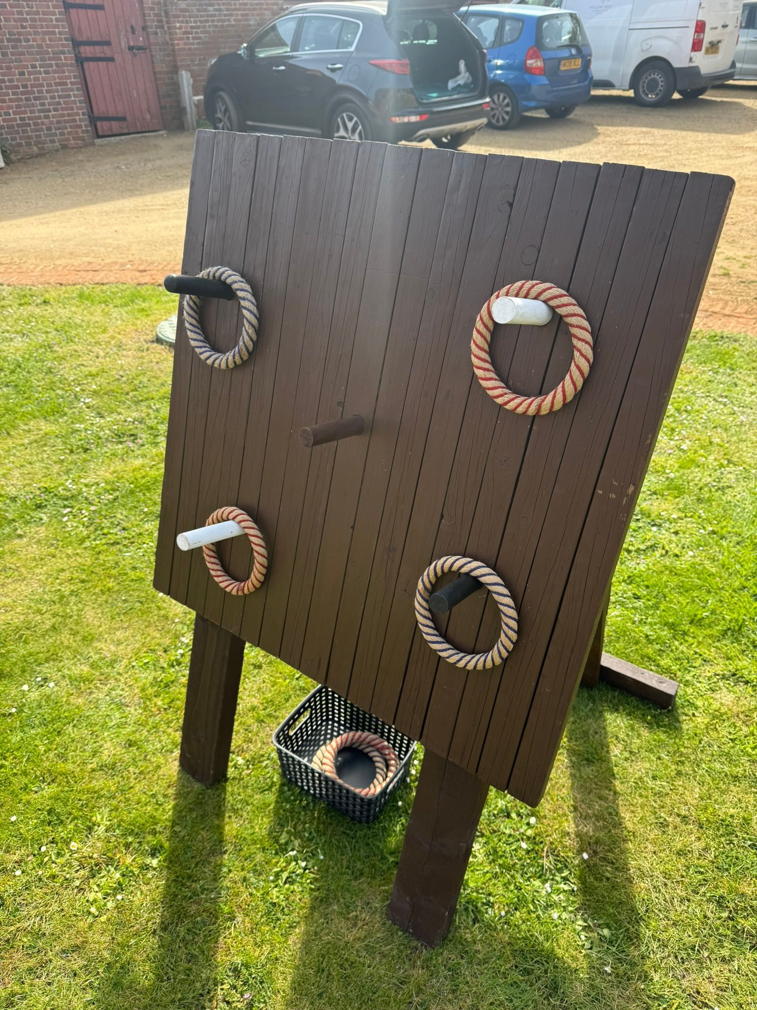 Wooden frame with large plastic coloured hoops.