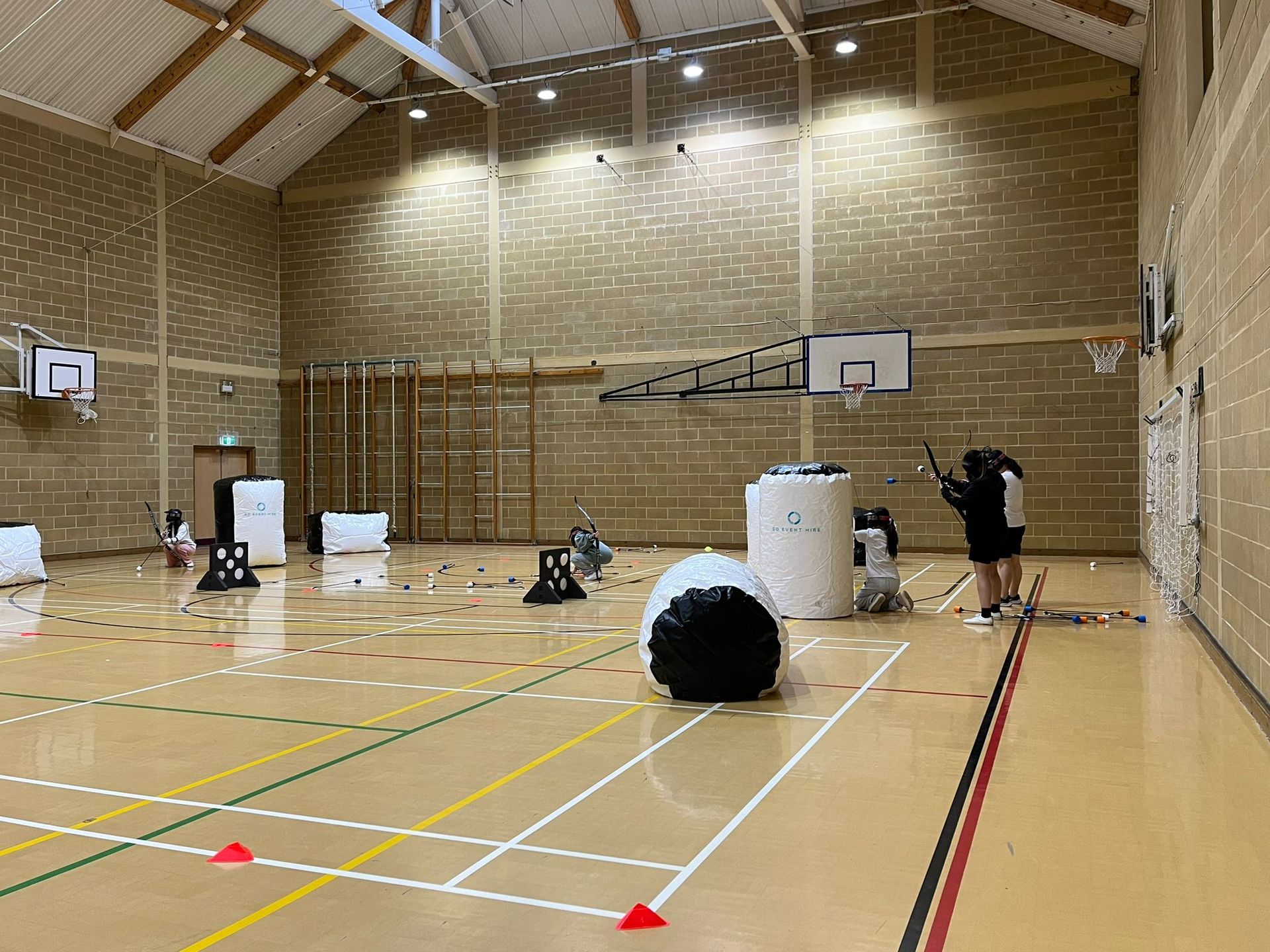 Archery tag set up indoors in a sports hall. Blow up bunkers.