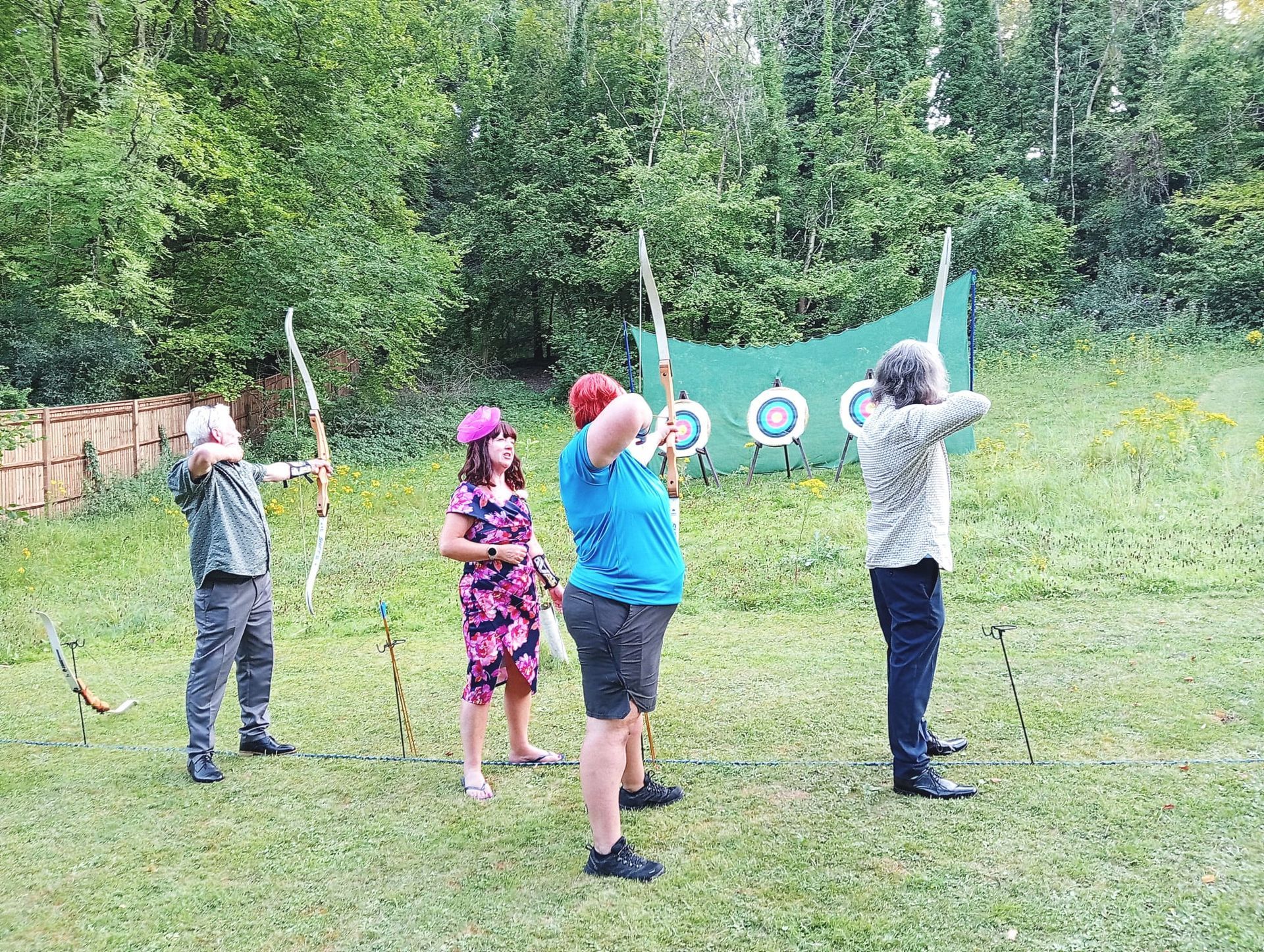 Archery hire in Hampshire, people holding bows and others watching
