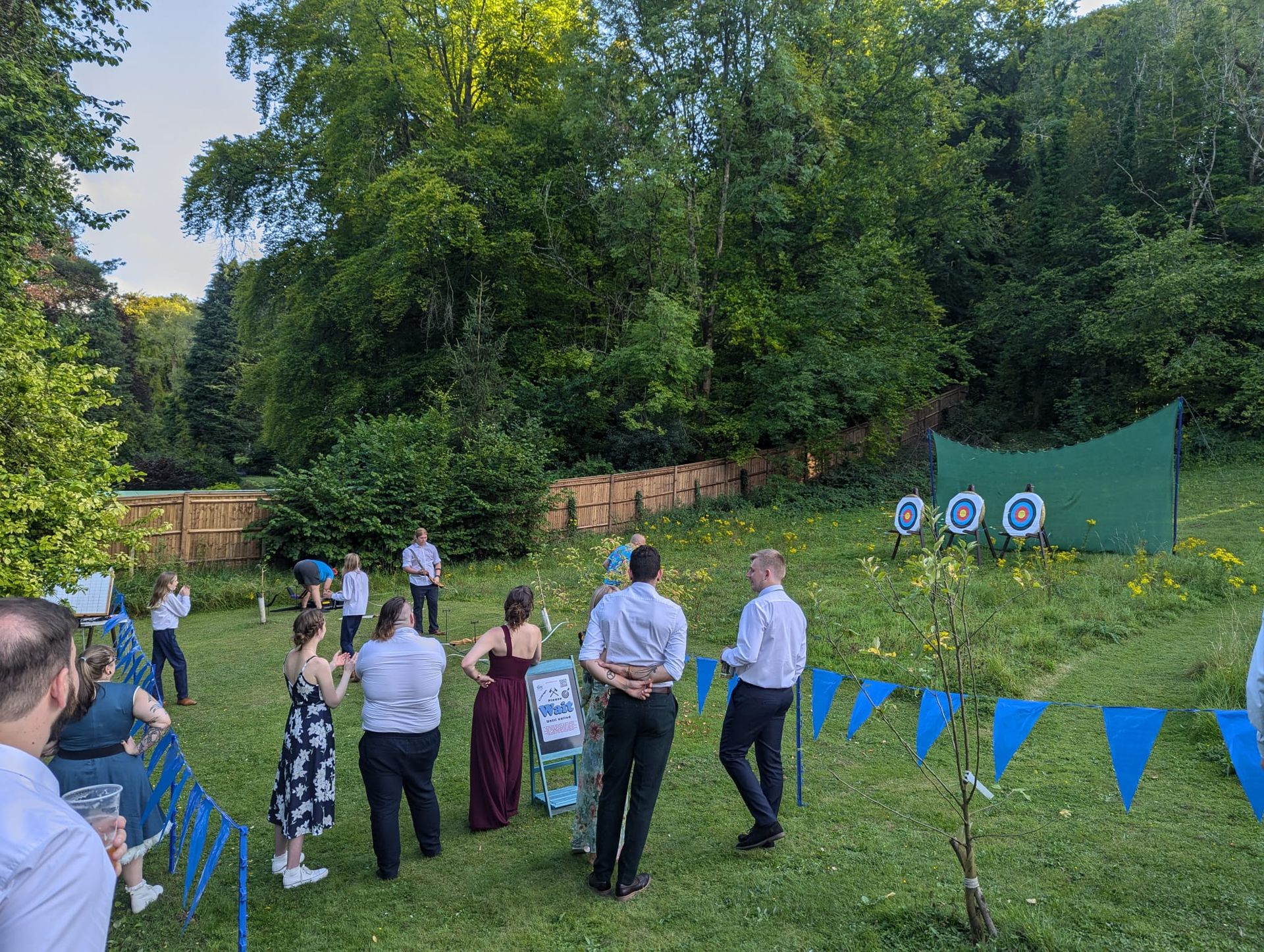 Archery hire in Hampshire, people holding bows and others watching