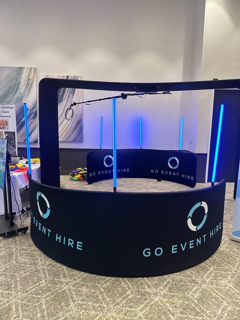 SKY 360 Plus set up at the Hilton Hotel. Black barriers with GO Event Hire logos. Large vertical overhead 360 video booth.