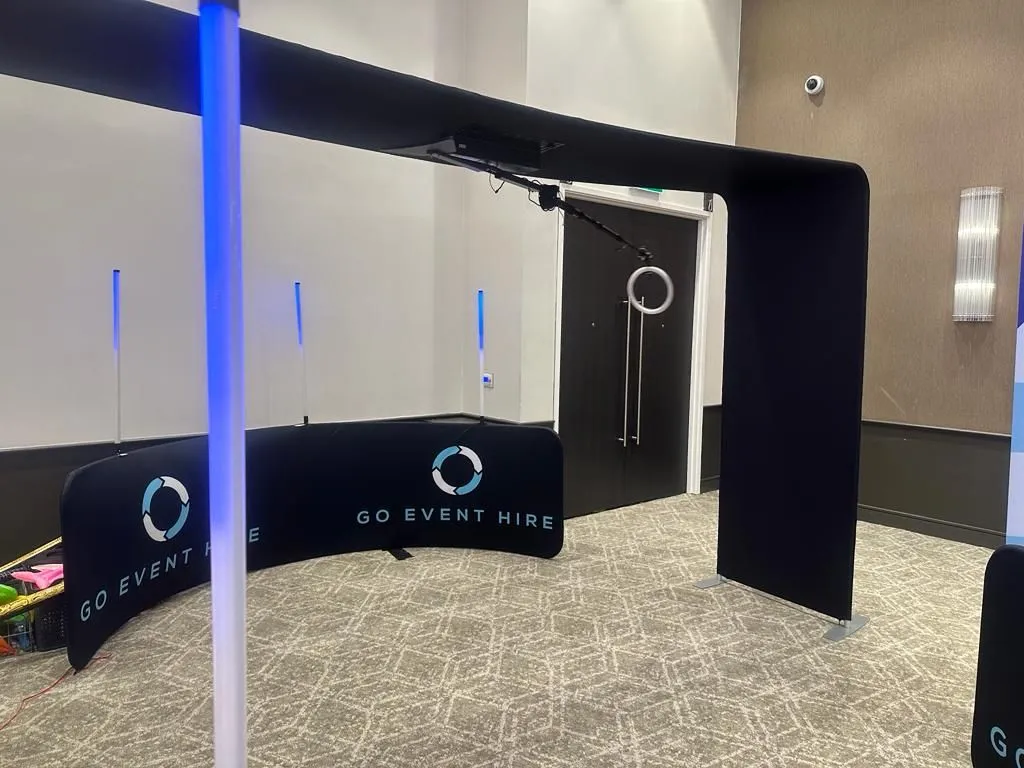 SKY 360 Plus set up at the Hilton Hotel. Black barriers with GO Event Hire logos. Large vertical overhead 360 video booth.