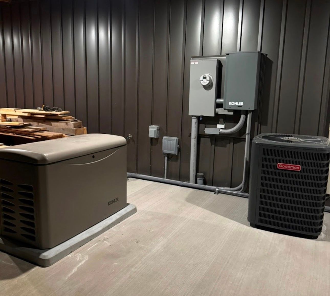 Outdoor standby generator installed on a concrete pad next to a residential home.