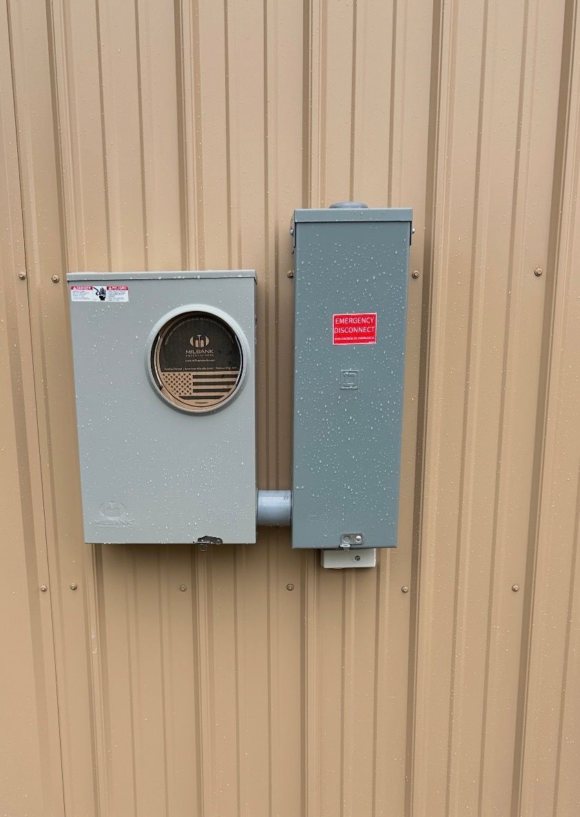 Electrician installing organized wiring inside a newly upgraded main electrical panel.