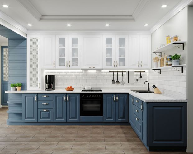 Electrician installing recessed LED lighting in a kitchen remodel