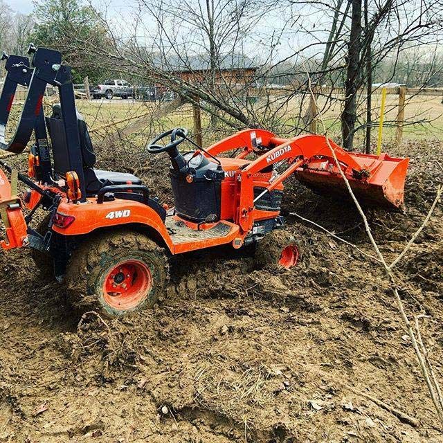 A Kubota Tractor is Stuck in the Mud — Ken Mills Machinery in Kingaroy, QLD