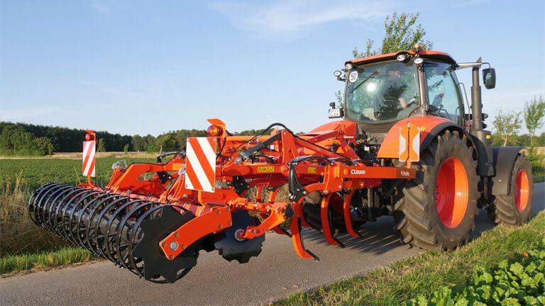 A Tractor is Plowing a Field With Discs — Ken Mills Machinery in Kingaroy, QLD