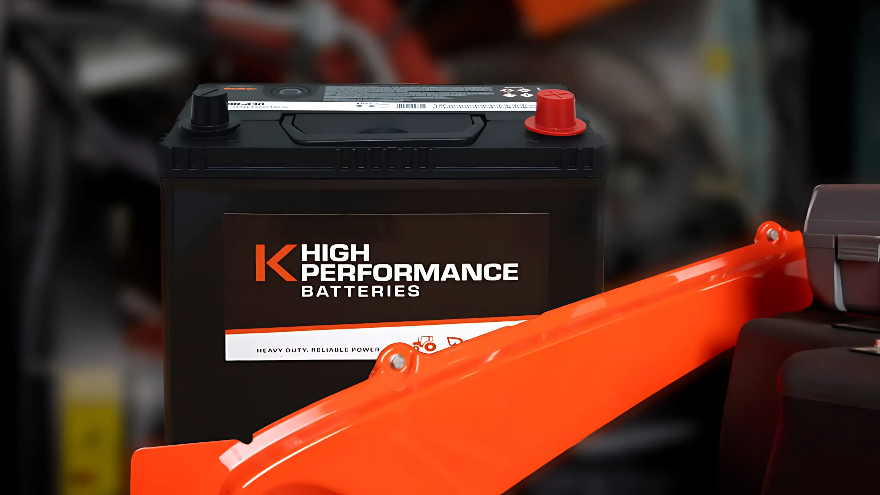 A high performance battery is sitting on top of a car engine. — Ken Mills Machinery in Kingaroy, QLD