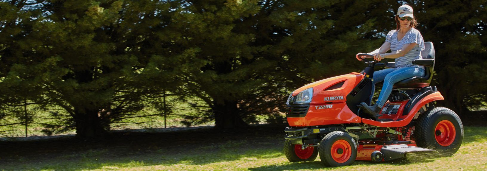 Orange Riding Lawn Mower on Green Grass — Ken Mills Machinery in Eidsvold, QLD