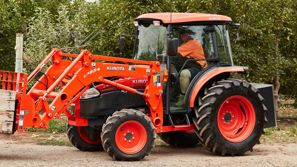 A Red Tractor is Parked in Front of a Building — Ken Mills Machinery in Kingaroy, QLD