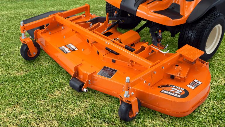 Orange Riding Lawn Mower Deck Attachment on Grass — Ken Mills Machinery in Monto, QLD