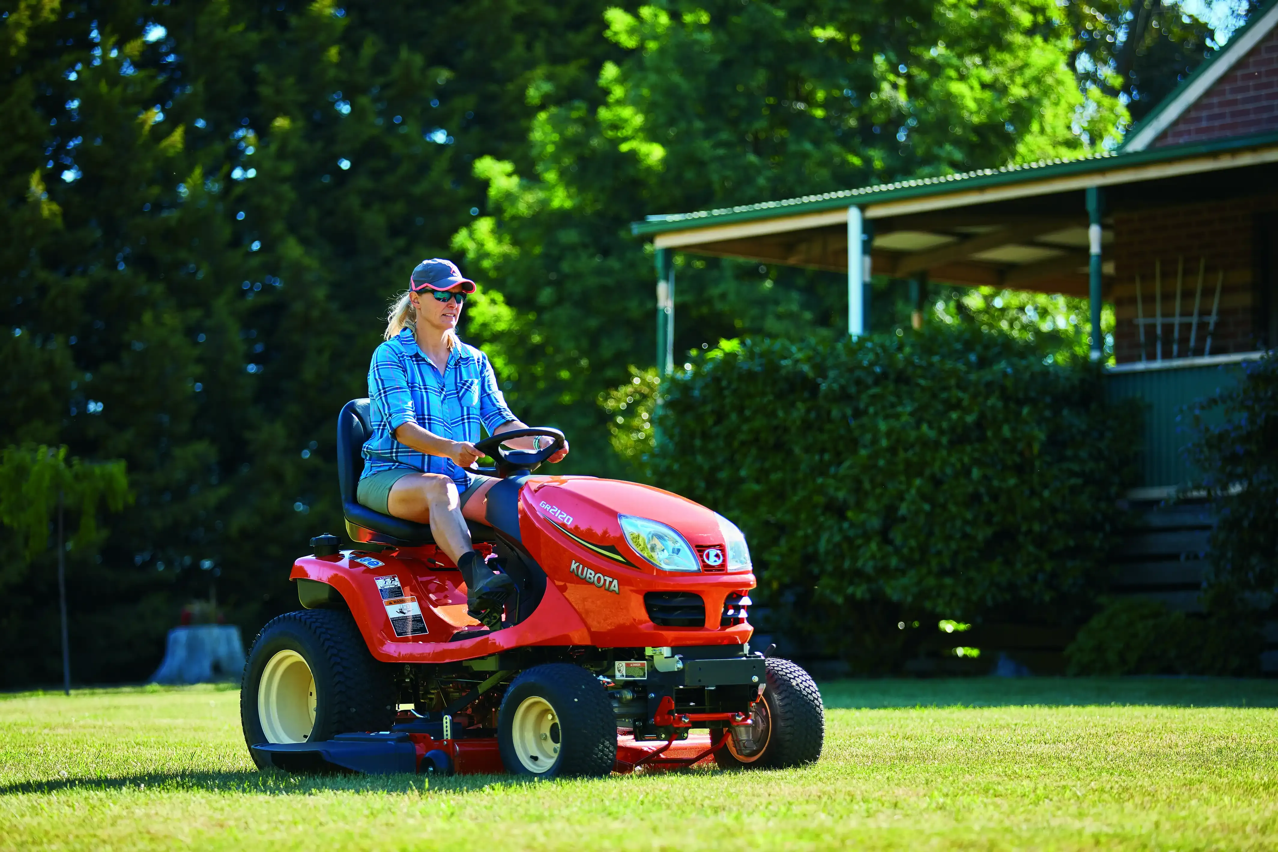 A Chainsaw is Sitting in the Grass Next to a Bowl of Tools — Ken Mills Machinery in Kingaroy, QLD