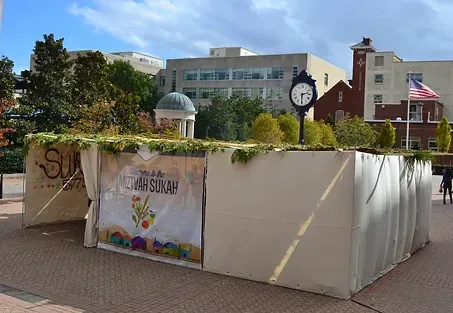 There is a clock on the side of the building in the background.