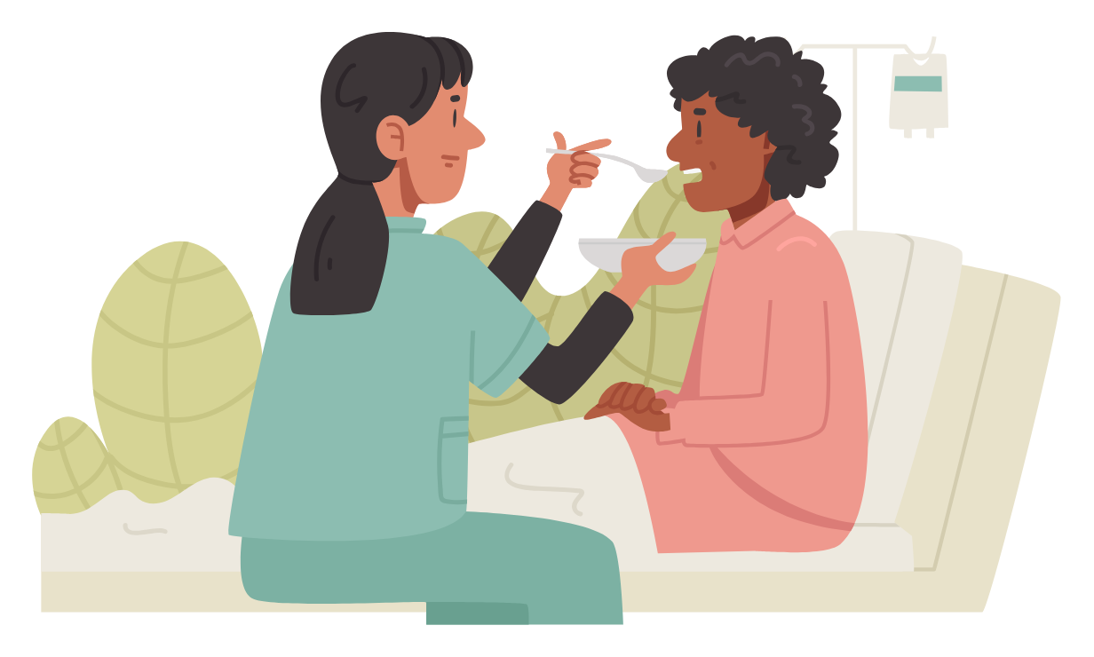 Healthcare worker feeding a patient on a couch, with a pill bottle nearby.