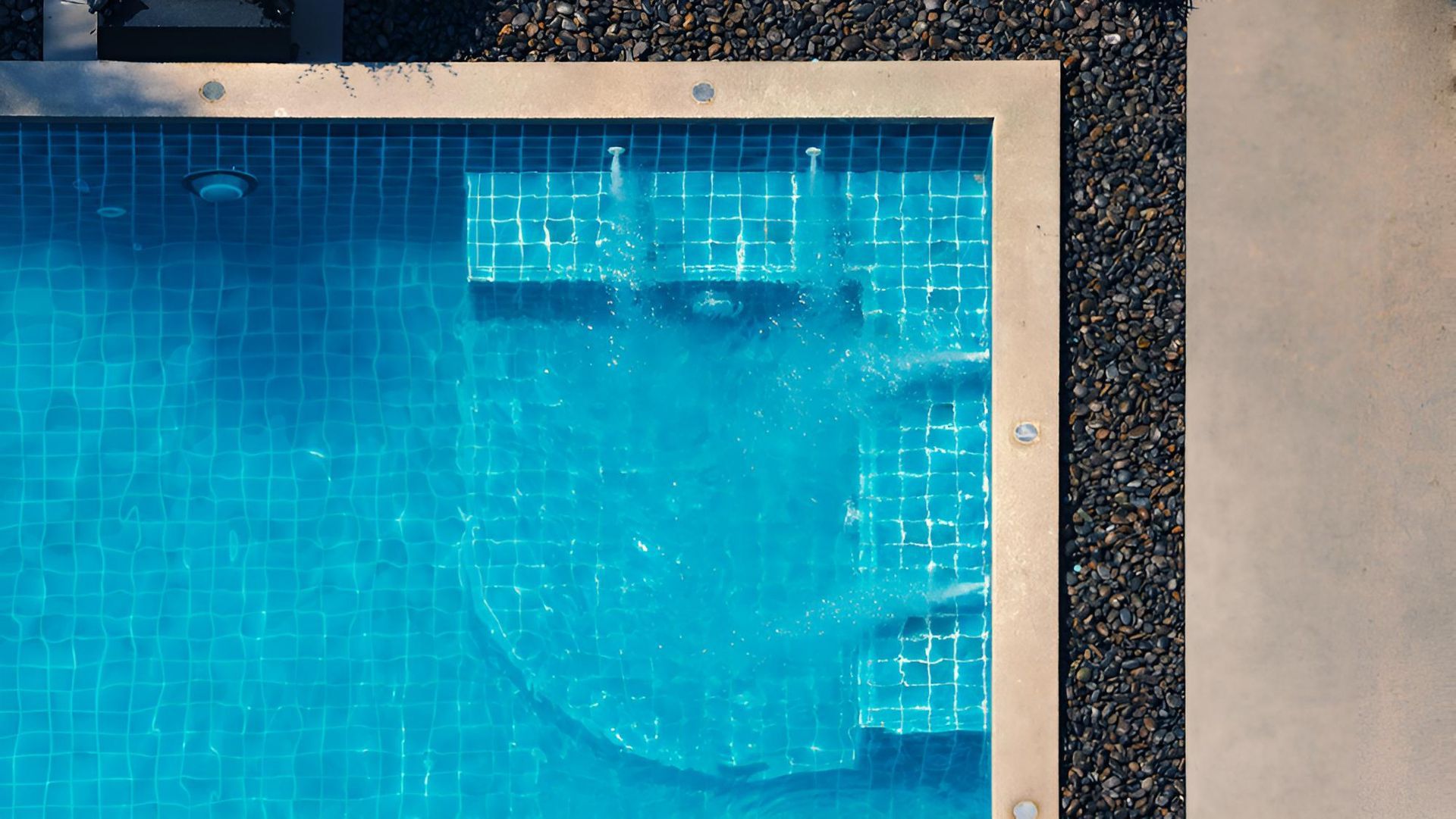 An Aerial View Of A Large Swimming Pool Filled With Blue Water — All Bright Pool Care In Laurieton, NSW
