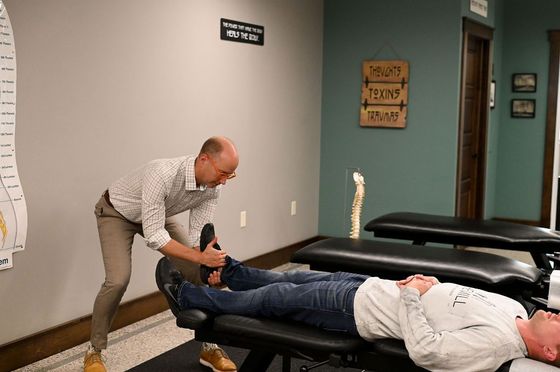 Dr. John doing an extremity adjustment