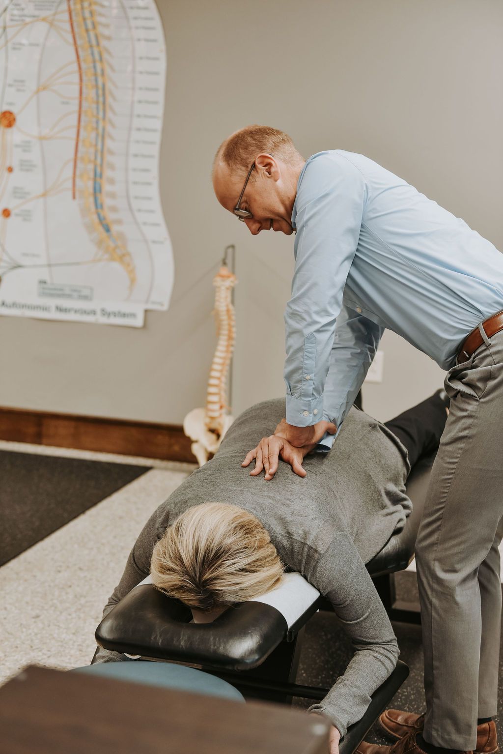 Dr. John adjusting woman