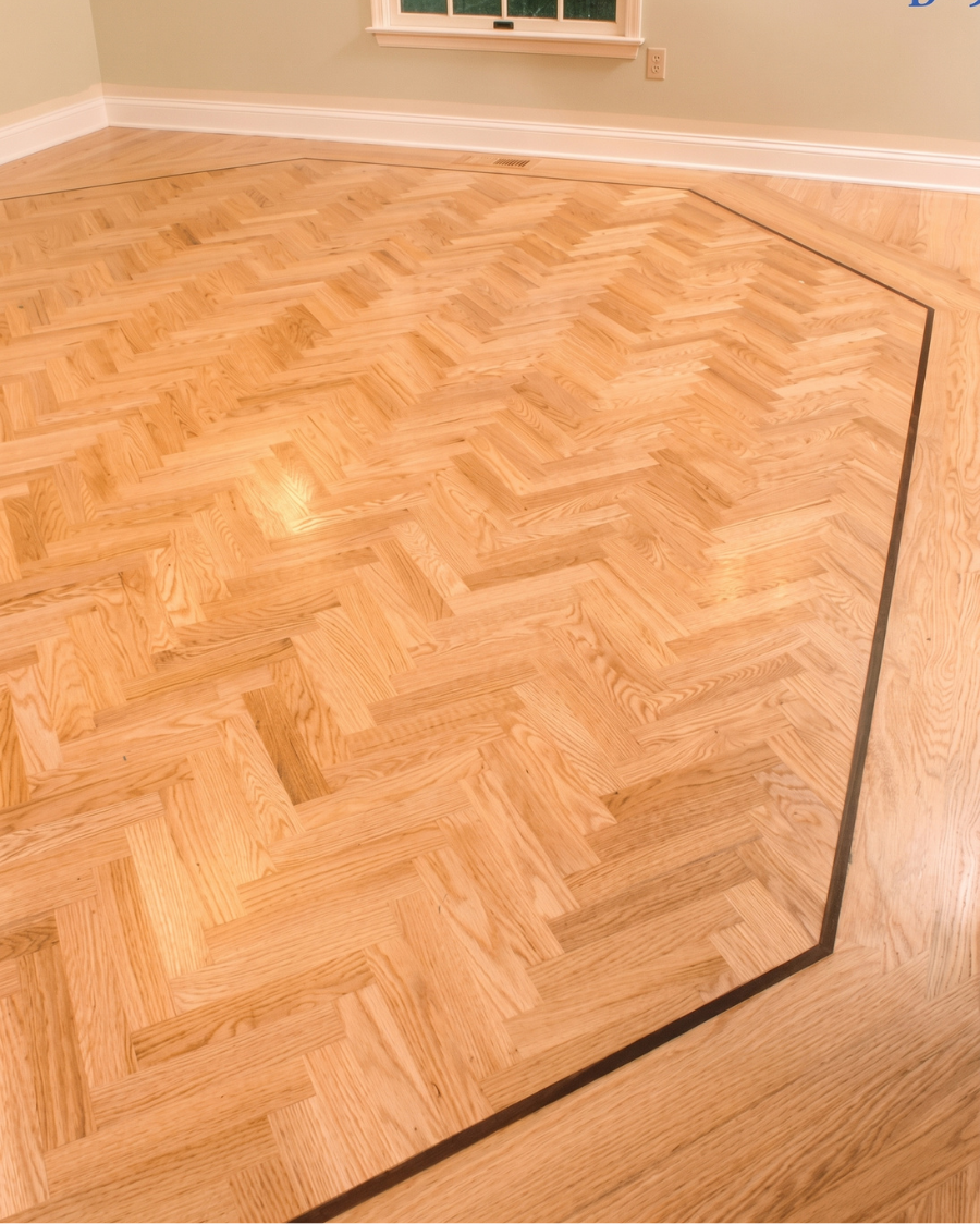 Parquet wood floor with a dark border in a room, viewed from above