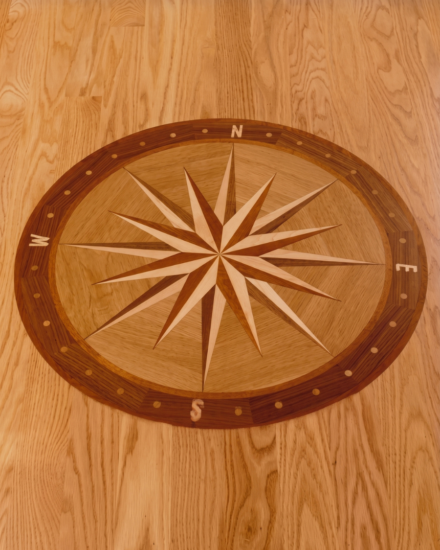 Wooden floor with a compass rose medallion in the center