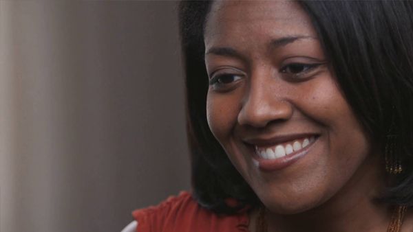 A close up of a woman 's face smiling