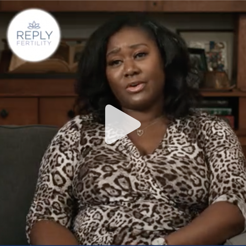 A woman in a leopard print shirt is sitting on a couch