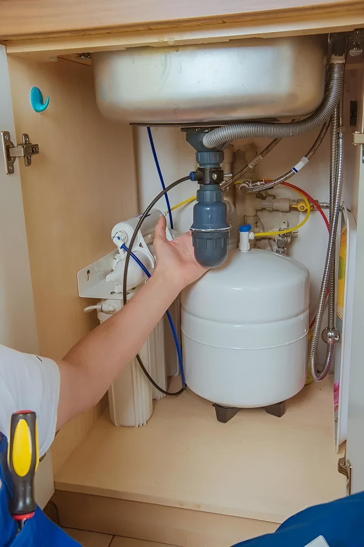Plumber is Fixing a Sink in a Kitchen — Wet & Dry Plumbing & Gas in Westbrook, QLD