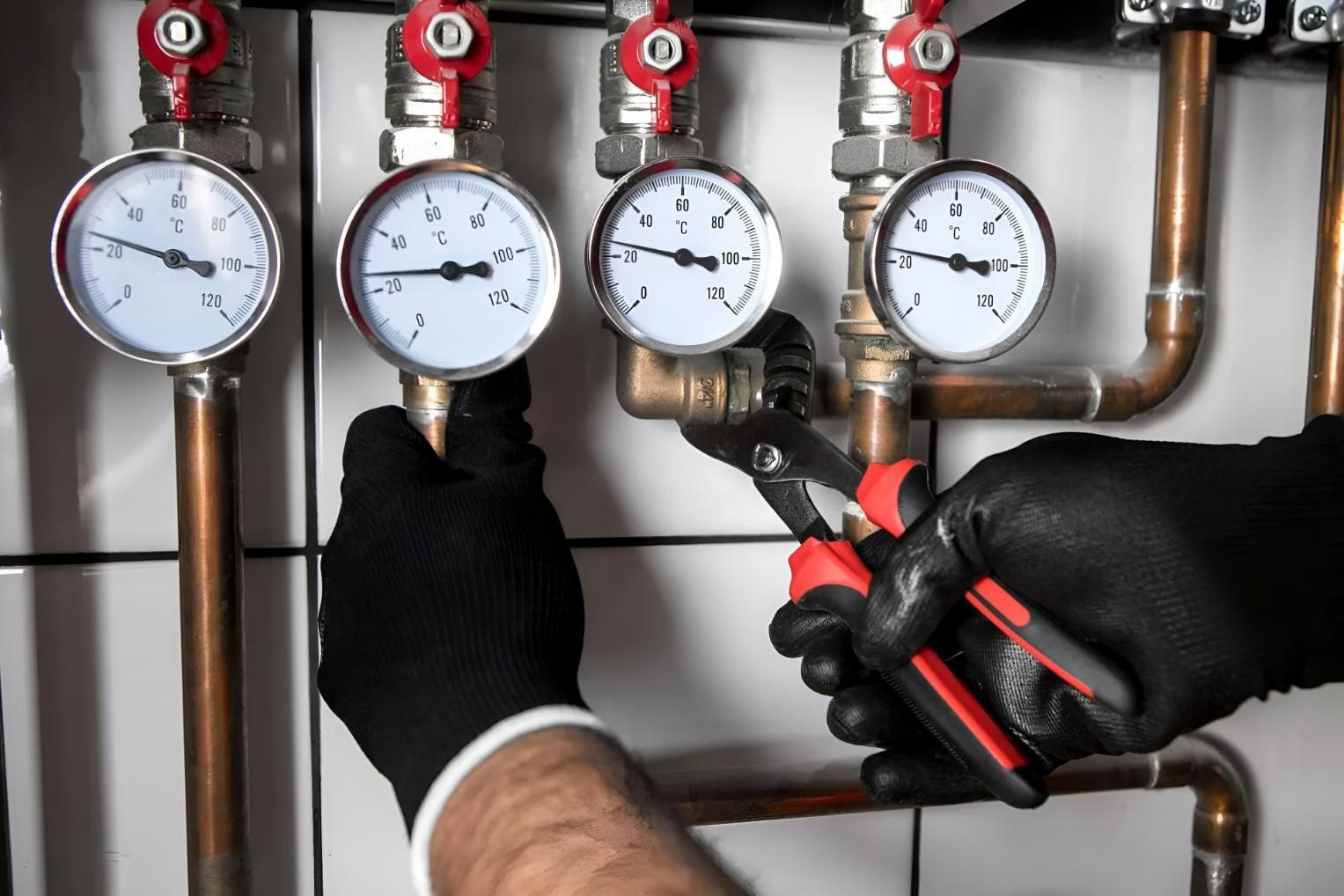 Plumber is Working on a Pipe With a Pair of Pliers — Wet & Dry Plumbing & Gas in Newtown, QLD