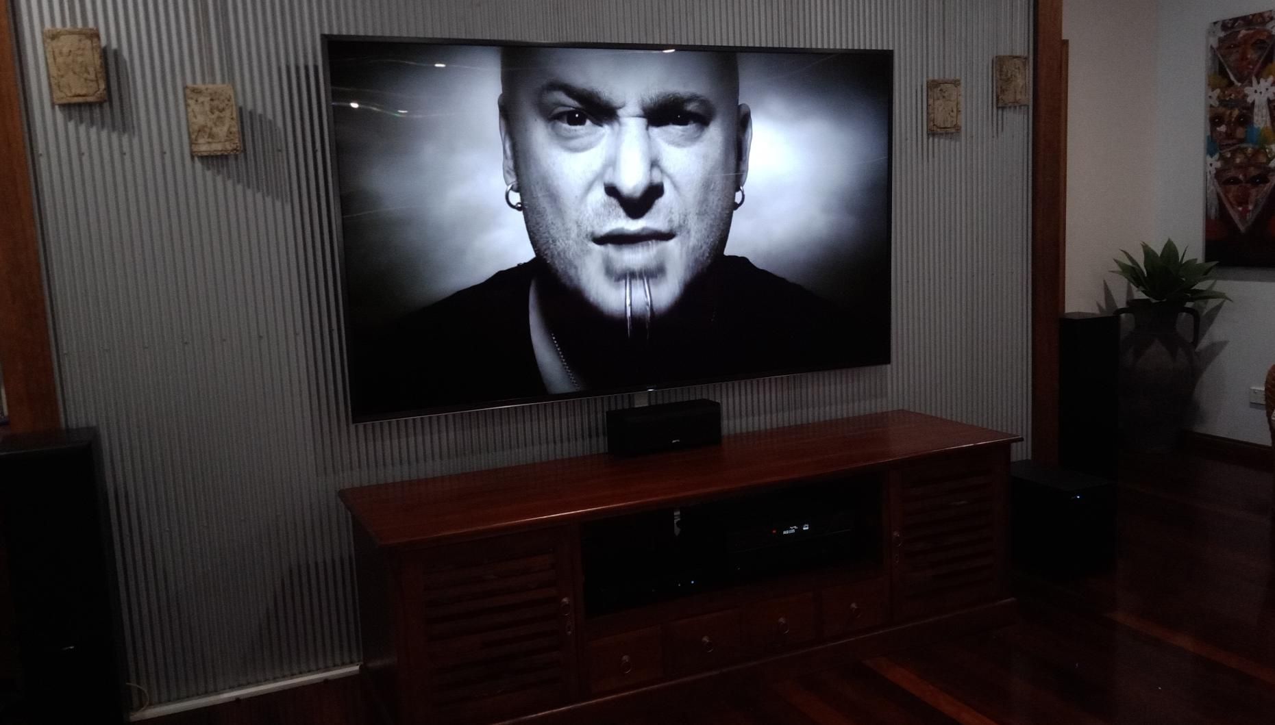 A Large Flat Screen TV Is Hanging On A Wall In A Living Room — Laurence Capocchi Antenna Guy In Trinity Beach, QLD