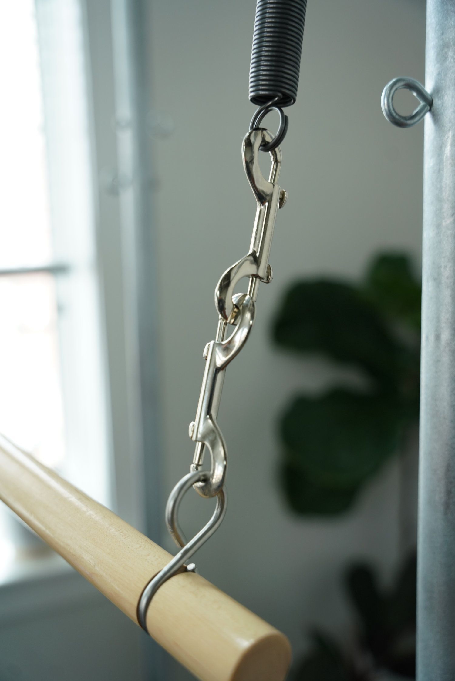 Close-up of a metal chain hook on Pilates Cadillac