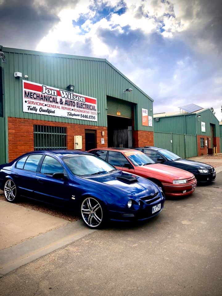 A Row of Cars Are Parked in Front of a Building — Jon Wilson Mechanical in Eaglehawk, VIC