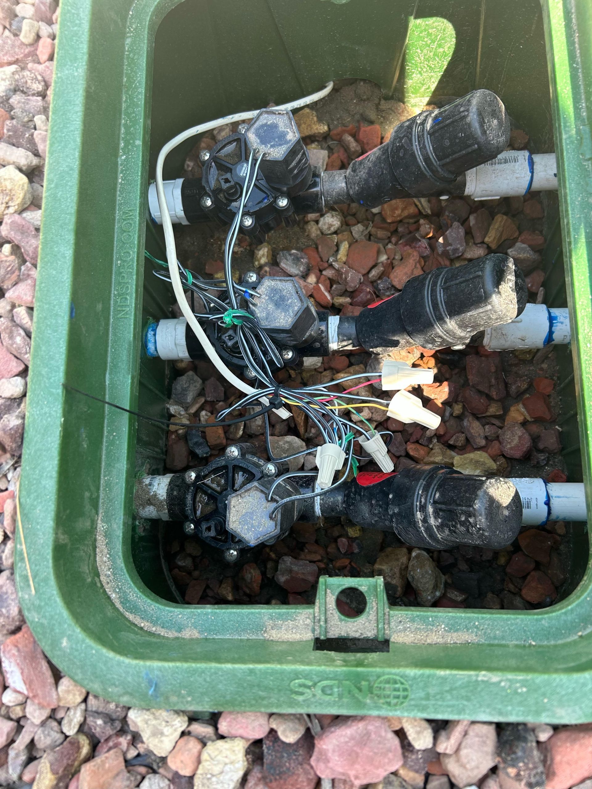 A green box with a bunch of wires coming out of it.