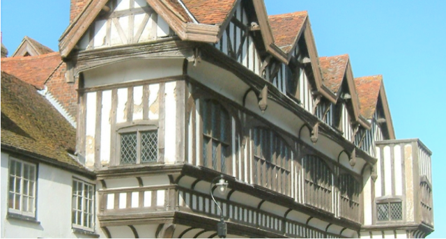 A large building with a balcony on the side of it
