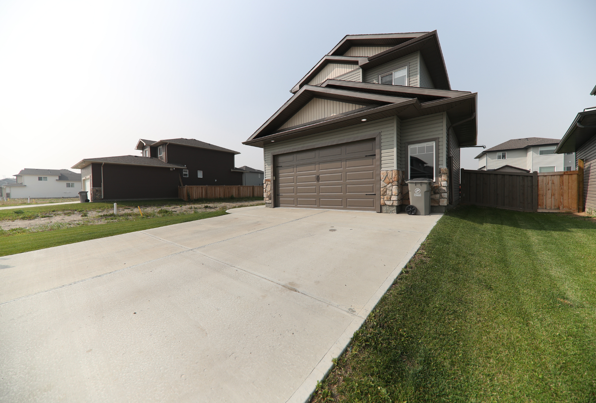 A large house with a concrete driveway leading to it