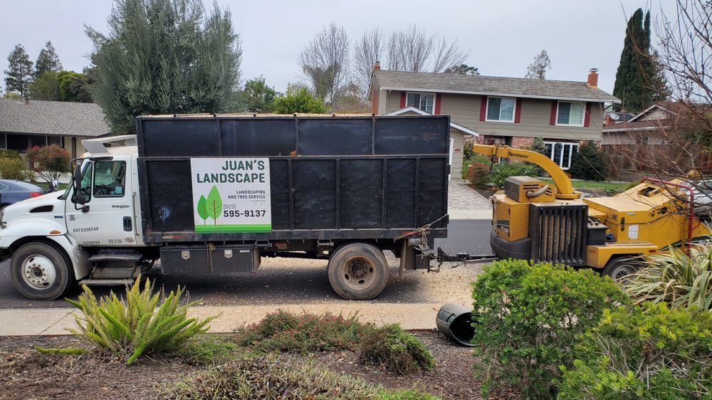 A james landscape truck is parked in front of a house.