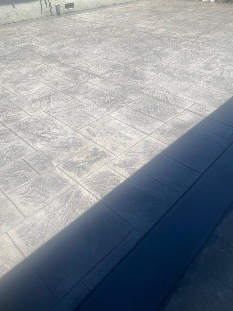 A close up of a concrete floor with a blue object in the foreground.