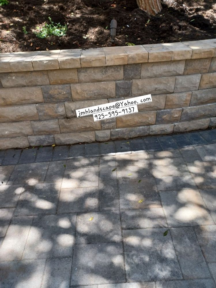 A brick wall with a phone number on it