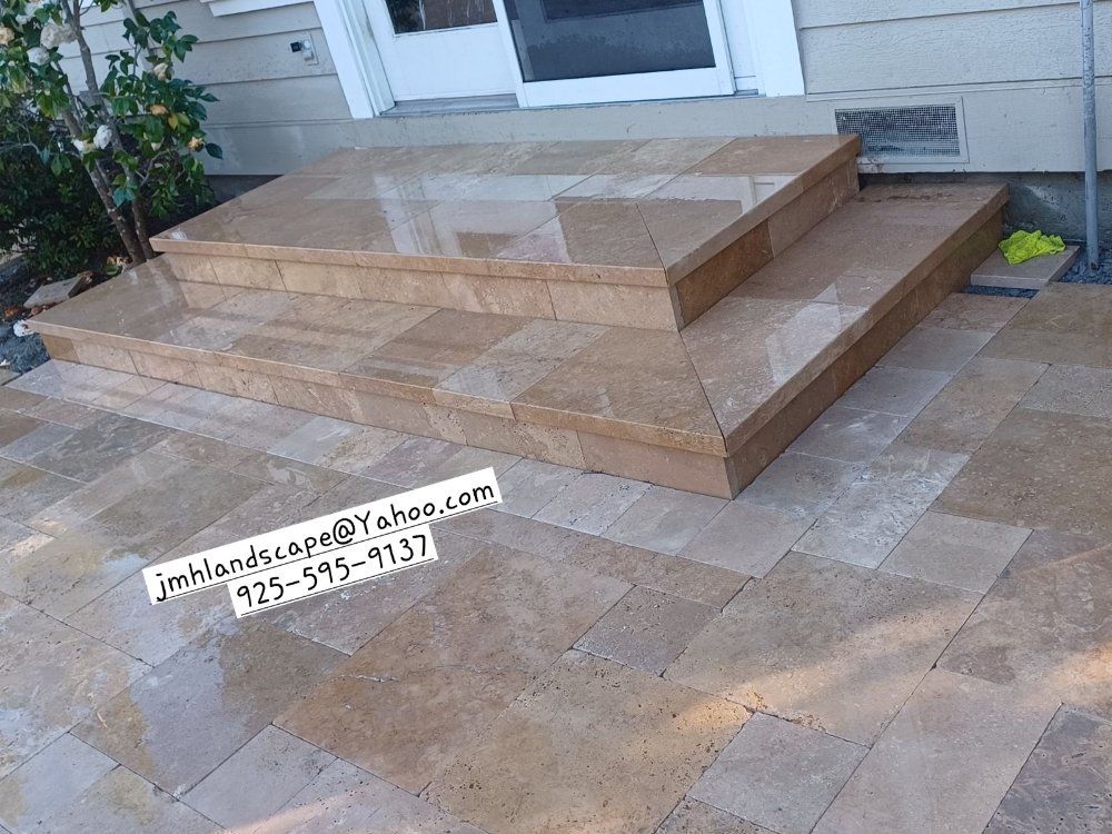 A set of stairs made of tiles in front of a house.