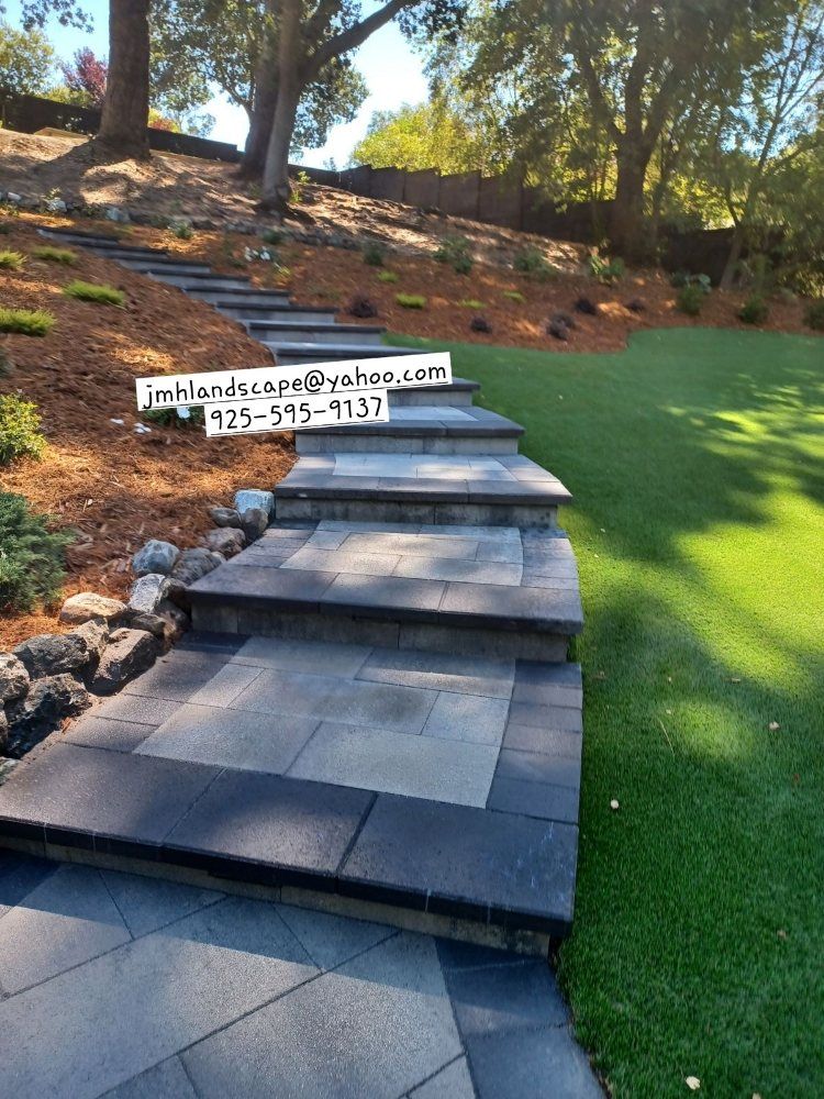 A set of stairs leading up to a grassy hillside.