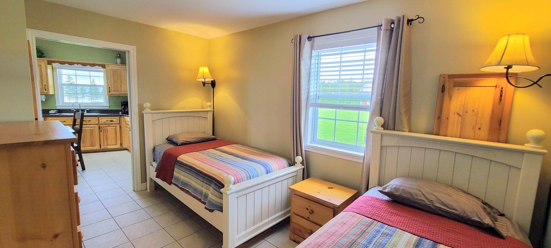 Bright bedroom, with two twin beds and nightstands.