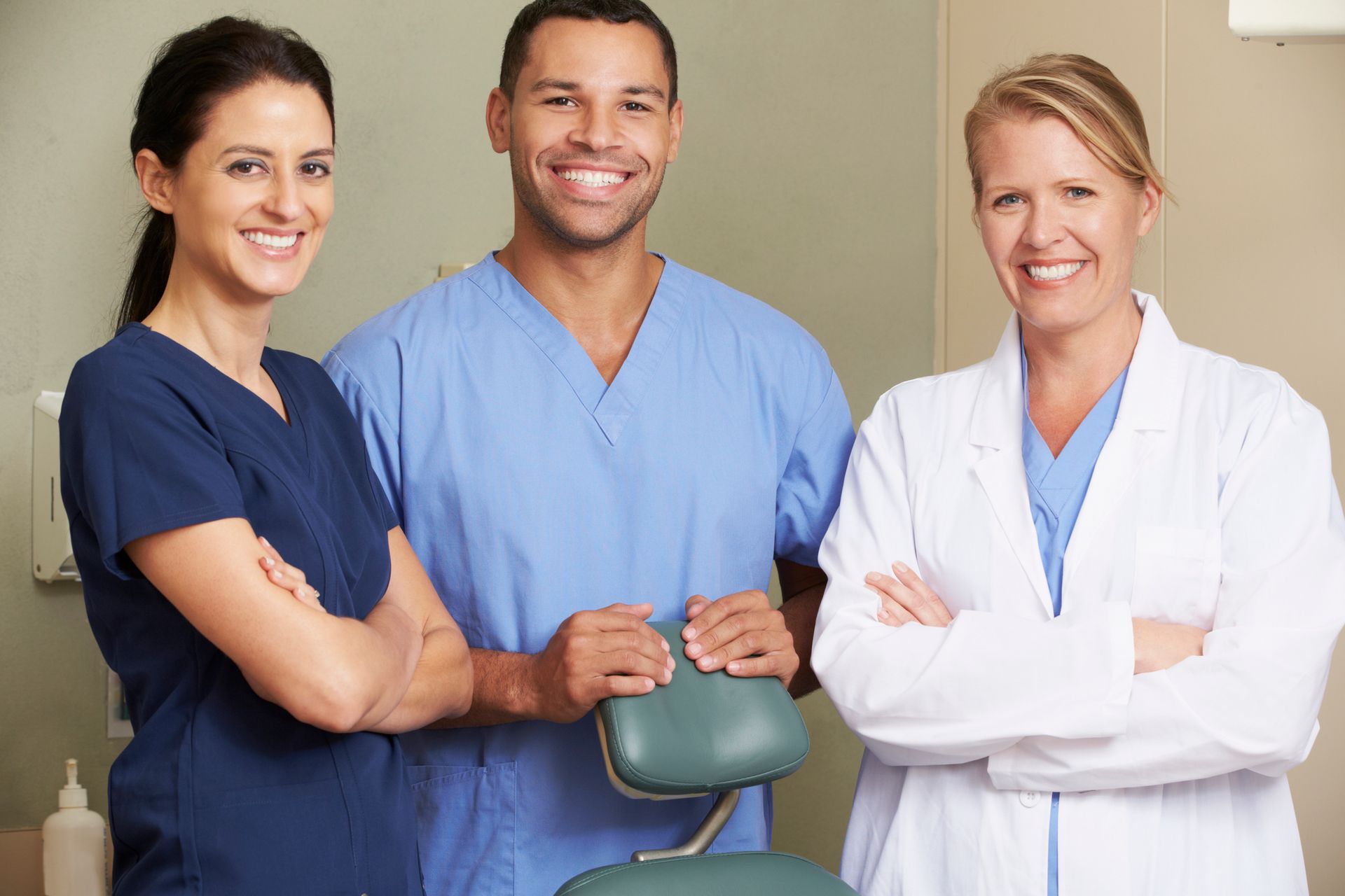 Portrait Of Dentist And Dental Nurses In Surgery