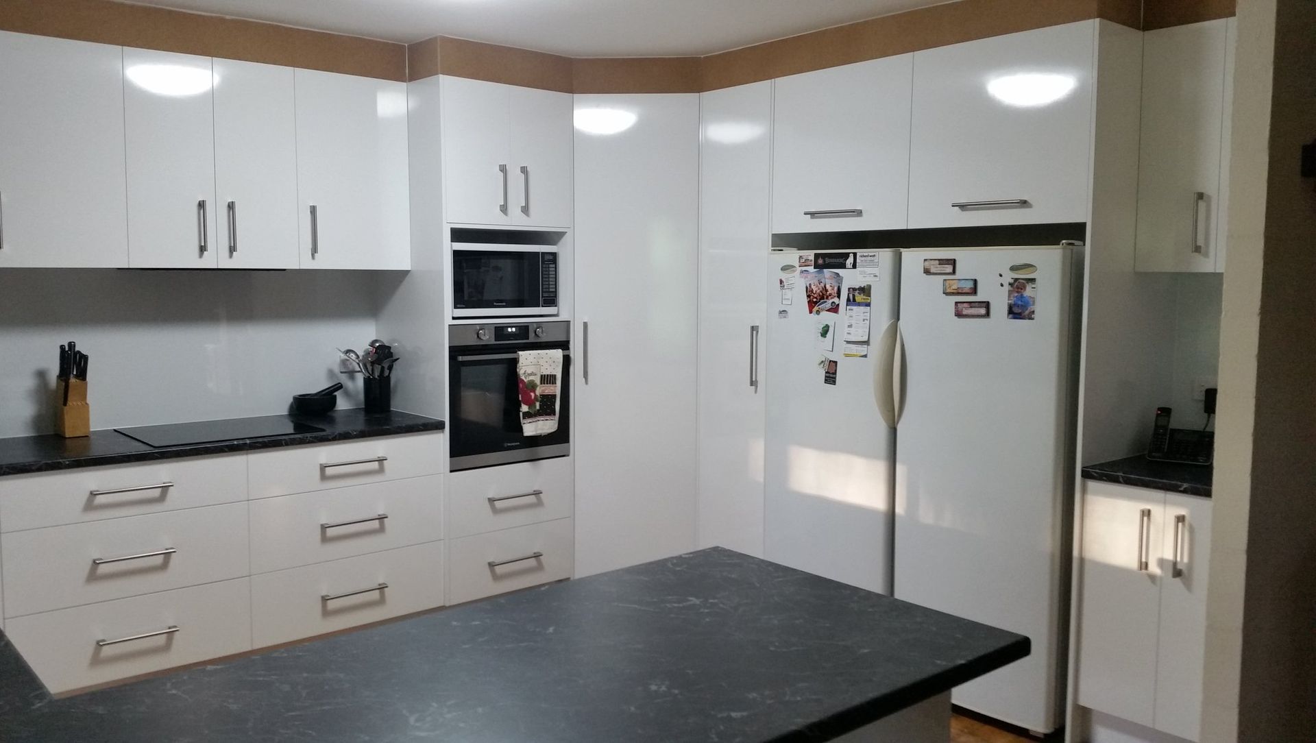 Kitchen With White Cabinetry, Dark Countertops, a Built-in Oven — Craftsmen Kitchens In Monkland, QLD