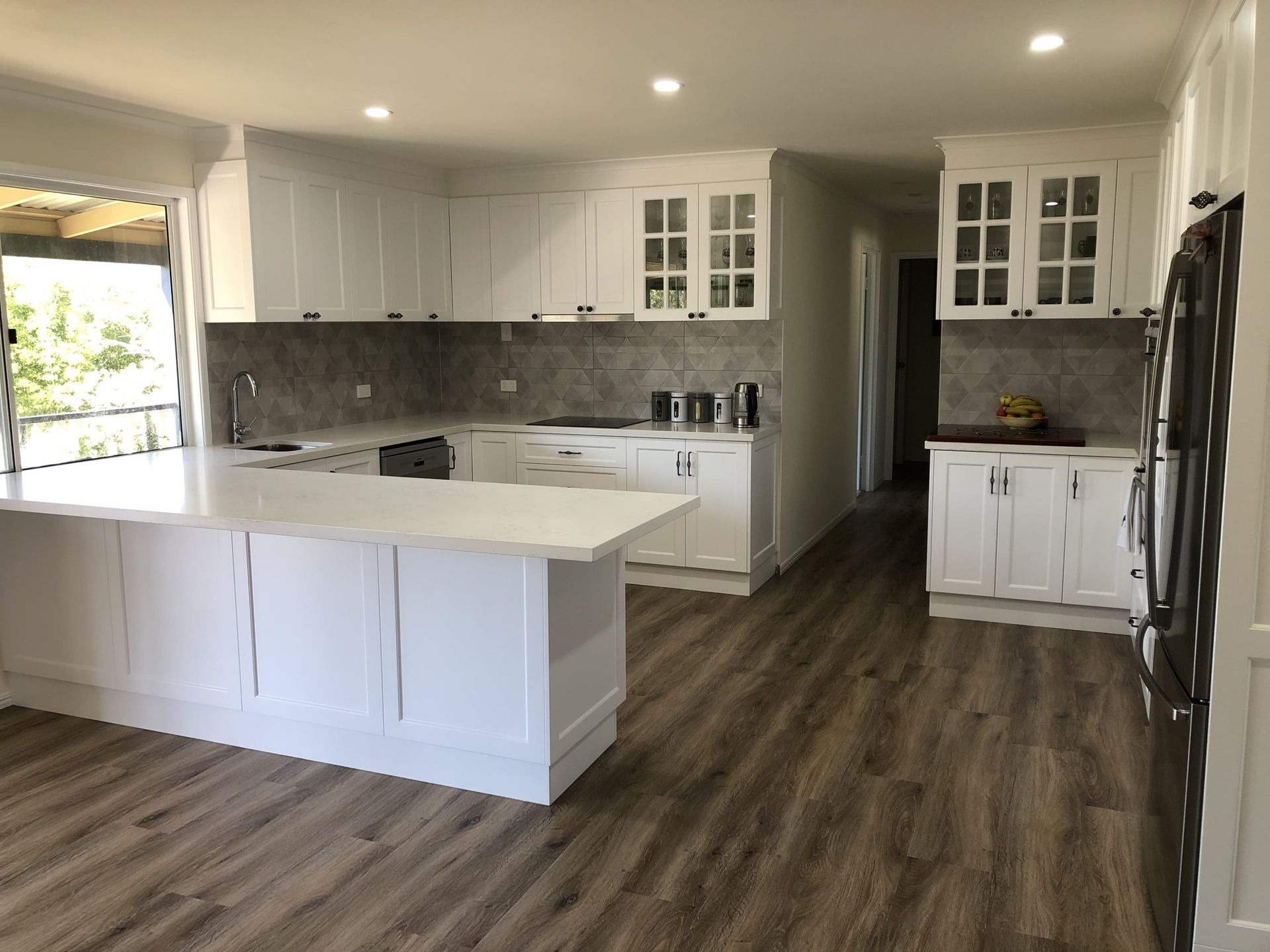 A Modern Kitchen With White Cabinetry, White Countertops — Craftsmen Kitchens In Monkland, QLD