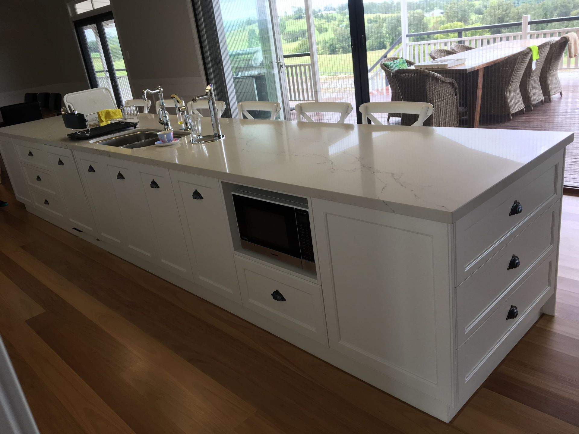 A Large White Kitchen Island With a Light Countertop — Craftsmen Kitchens In Monkland, QLD