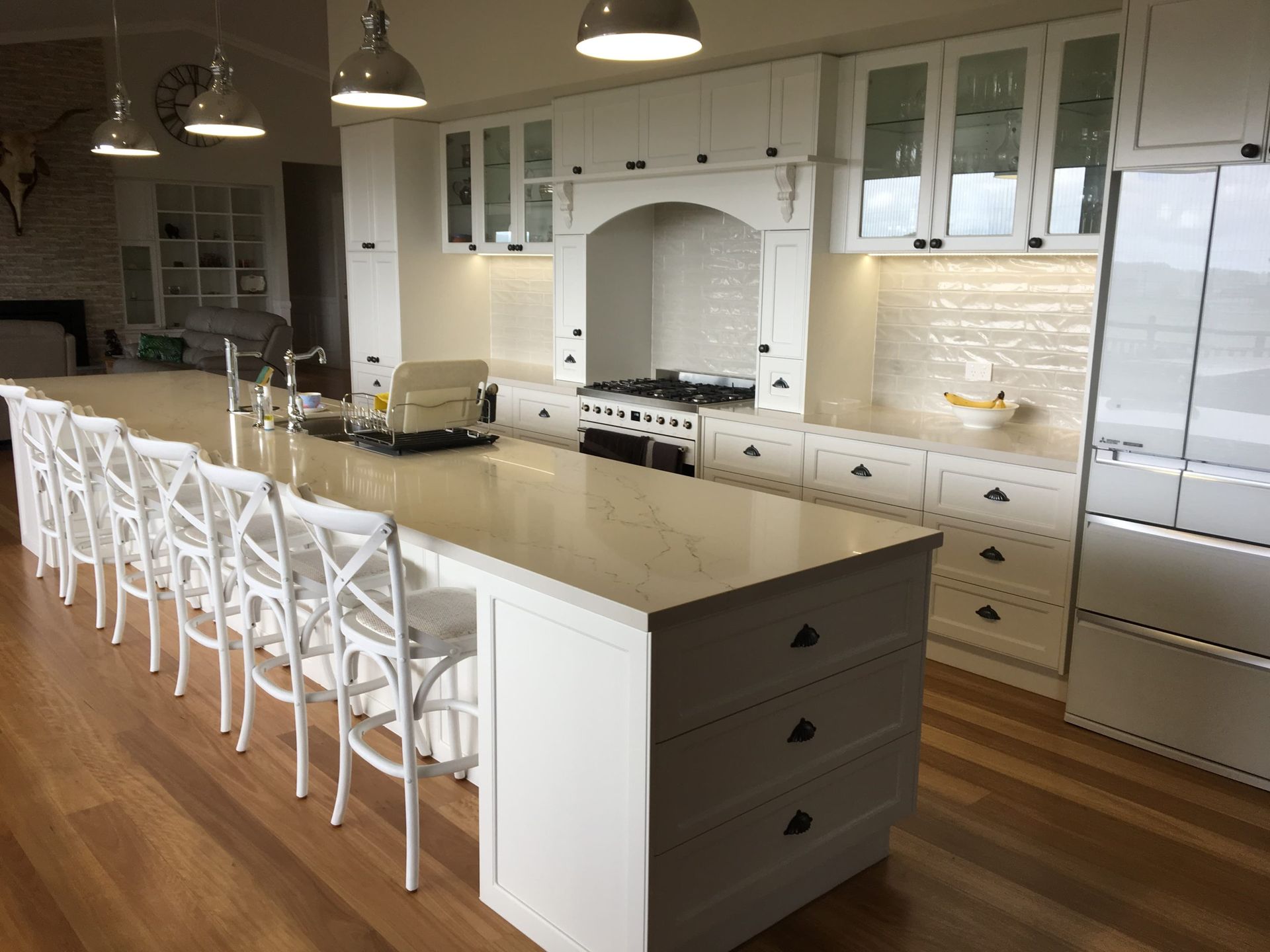 Modern White Kitchen With a Large Island, Six White Chairs — Craftsmen Kitchens In Monkland, QLD