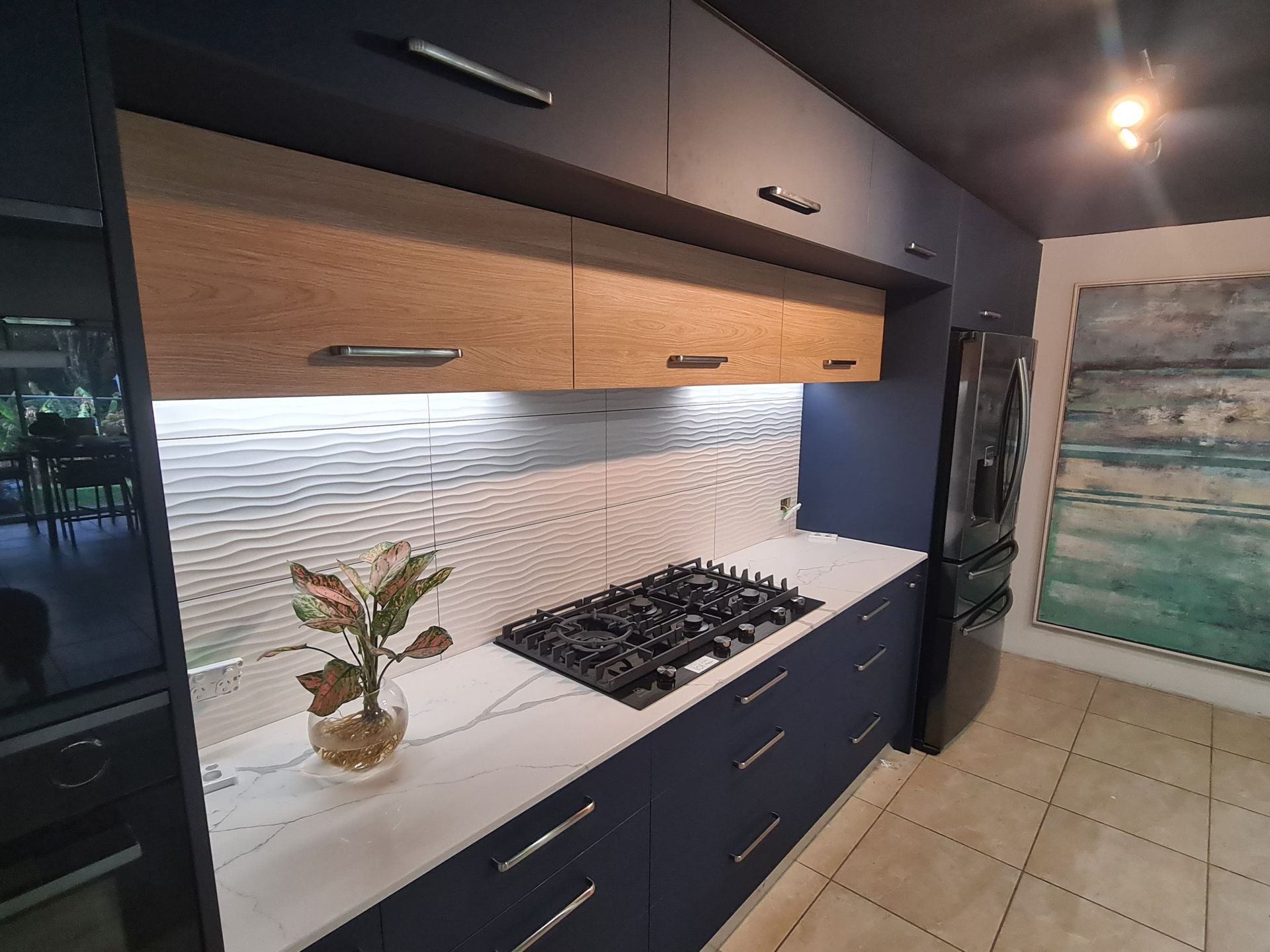 A Modern Kitchen Featuring Navy Blue Cabinets — Craftsmen Kitchens In Monkland, QLD