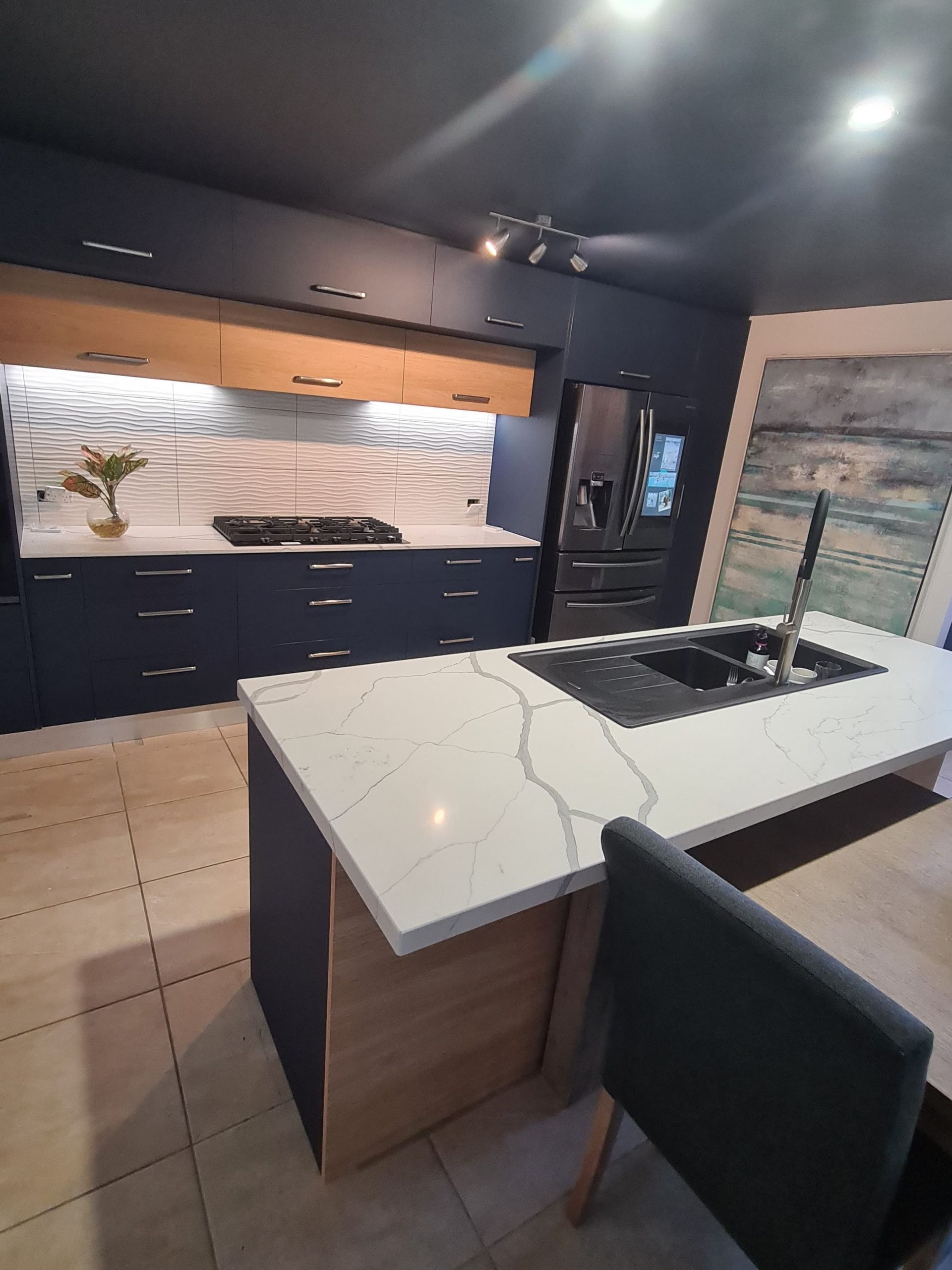 A Modern Kitchen With Navy Blue Cabinetry, Light Wood Accents — Craftsmen Kitchens In Monkland, QLD