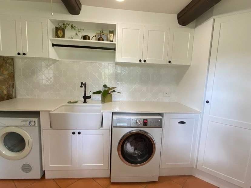 A Bright, White Laundry Room Featuring a Farmhouse Sink, a Washing Machine — Craftsmen Kitchens In Monkland, QLD