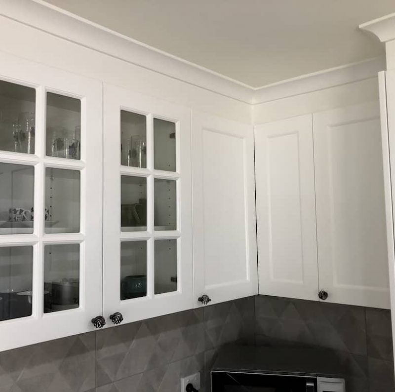 White Kitchen Cabinets, Two With Glass Doors, Above a Grey Geometric-tiled Backsplash — Craftsmen Kitchens In Monkland, QLD