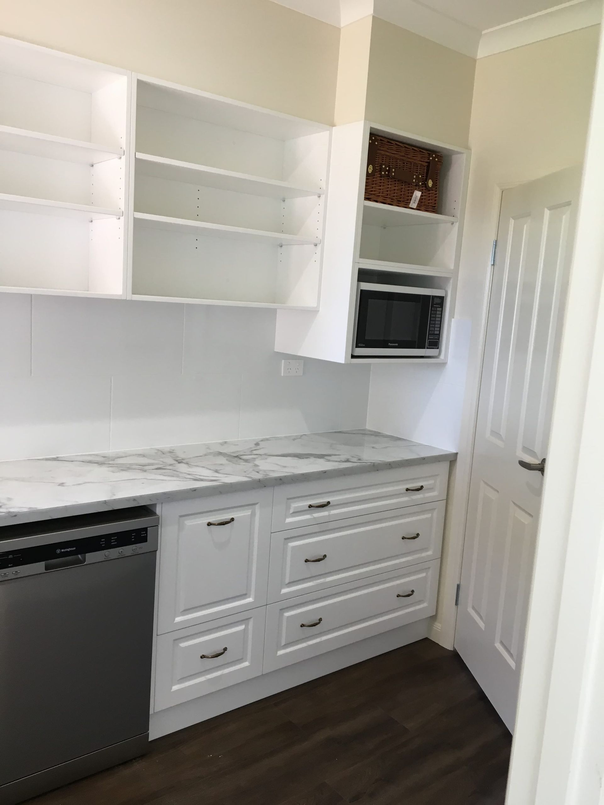A White Kitchen Laundry Area With Marble-look Counters — Craftsmen Kitchens In Monkland, QLD
